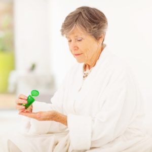 an older woman is shown taking medication