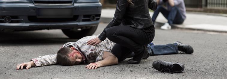 A woman attends to a pedestrian after he is hit by a car