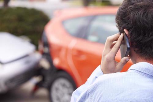a man calling a lawyer after a car accident in pearland.
